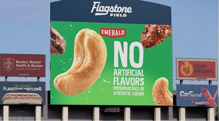 a picture of nuts floating on a baseball stadium screen