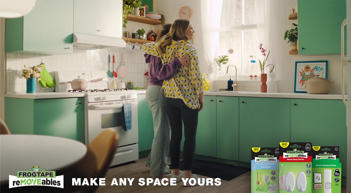 When it matters the most. Frogtape removeables. Mother and daughter hugging in the kitchen.