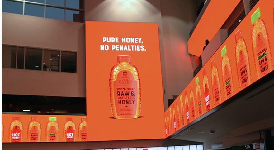 a big screen with package of nature nates honey displayed